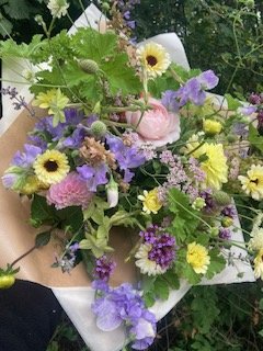 A bouquet of seasonal, pastel, locally grown flowers.