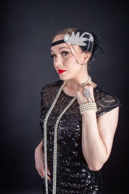 Headpiece with black feather and beautiful rhinestones.