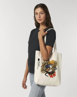 A printed undyed tote bag with margate film festival printed along one side and an illustrated graphic collage of eels, seaweed and an oyster in the middle