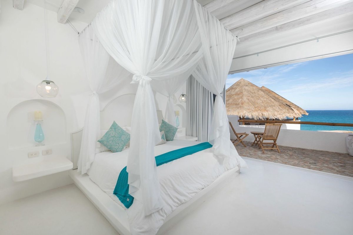A double room under a palapa roof