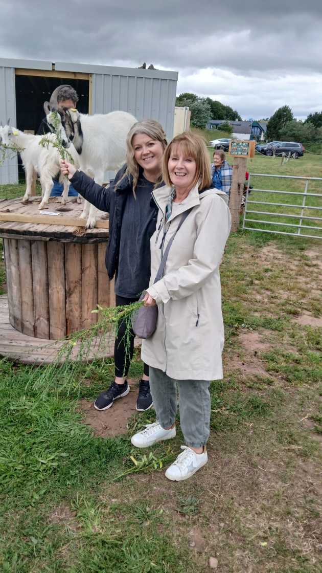 Mother and daughter enjoying feeding the goats at our goat therapy day