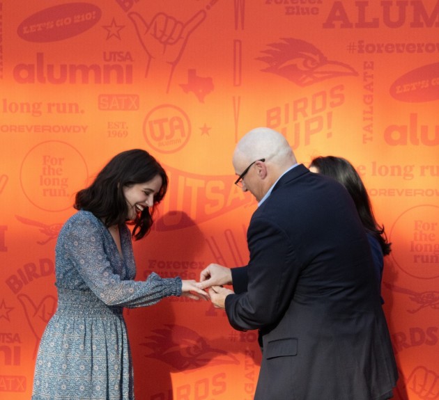 ring recipient receiving their ring from a family member