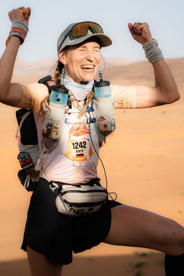Birte in running clothes in the desert cheering