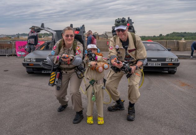 Three people dressed as Ghostbusters