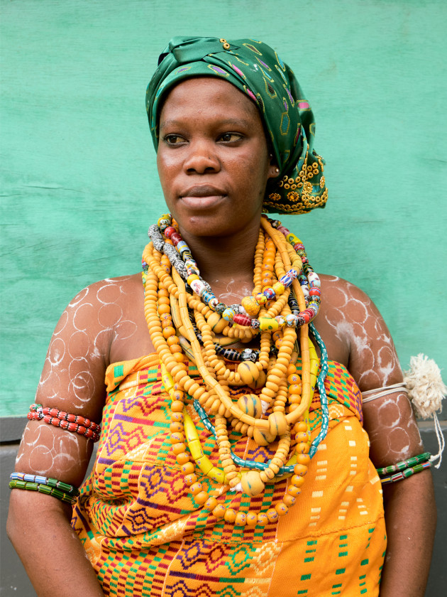 Portrait of a Black woman wearing traditional Yoruba clothes and a Yoruba female head scarf