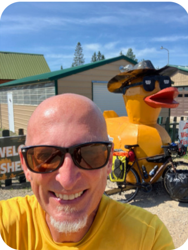 Cliff Brown selfie, smiling with a giant toy duck in the background