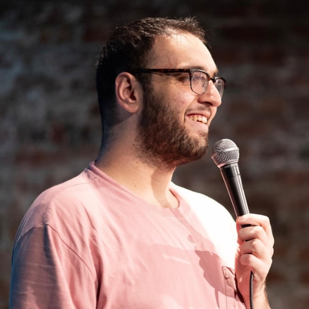 Danny Braff performing stand-up comedy at a live comedy show in Saratoga Springs